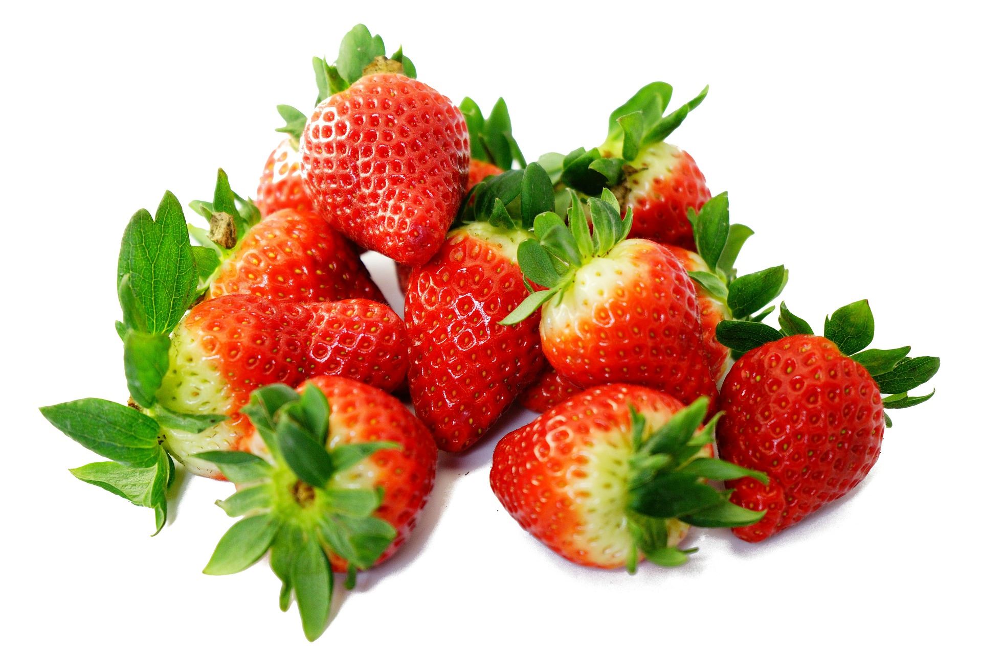 A pile of green and red strawberries